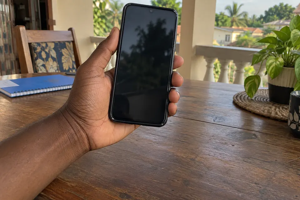 Phone held in one hand on a veranda